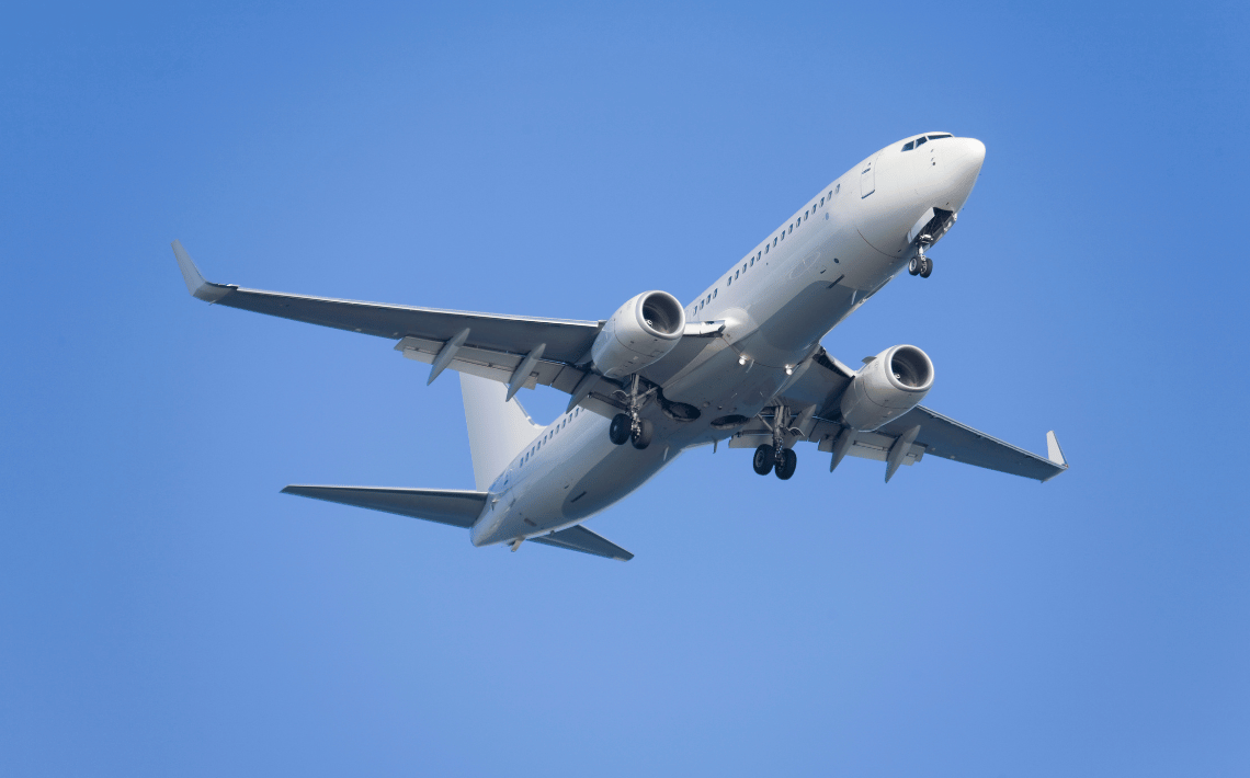 aeroplane flying up against blue sky