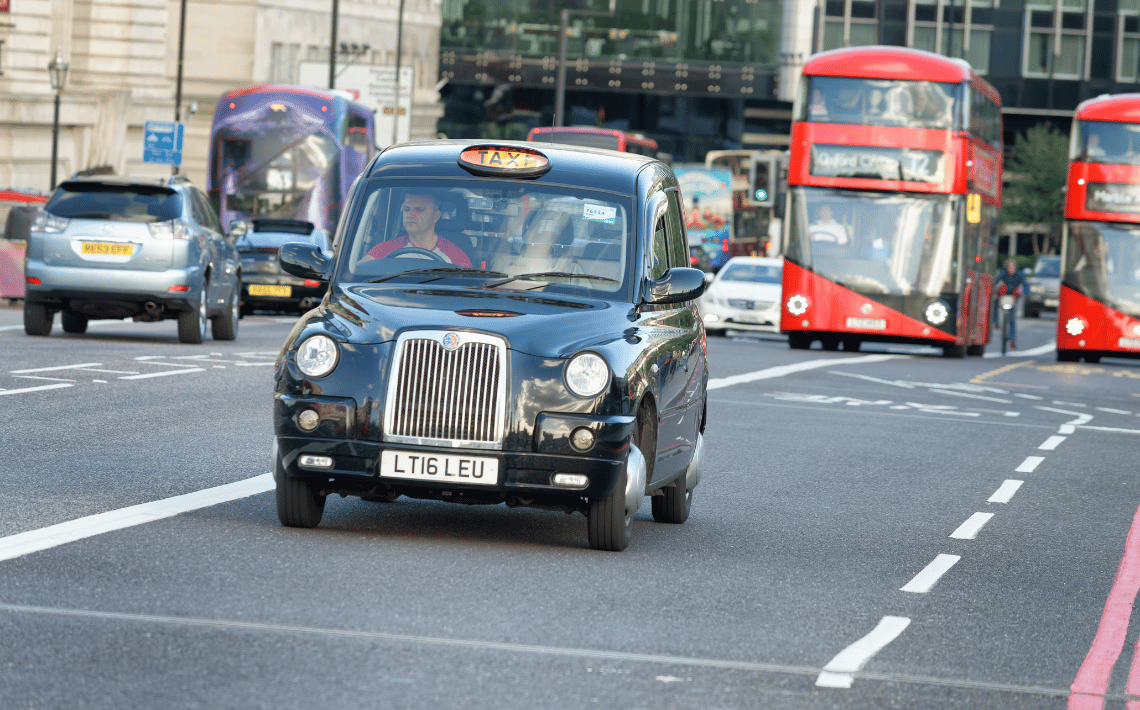 black cab driving on road